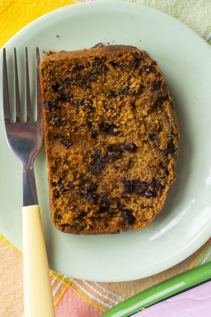 slice of cucumber bread with chocolate chips on plate.