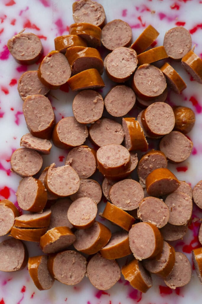 sliced kielbasa on cutting board.