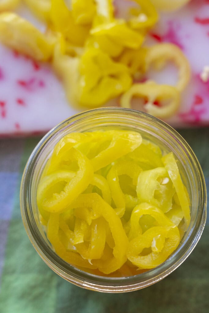 jar filled with sliced banana pepper rings.