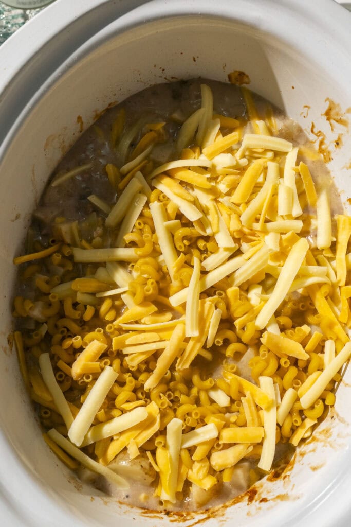 shredded cheese and noodles added into crockpot.
