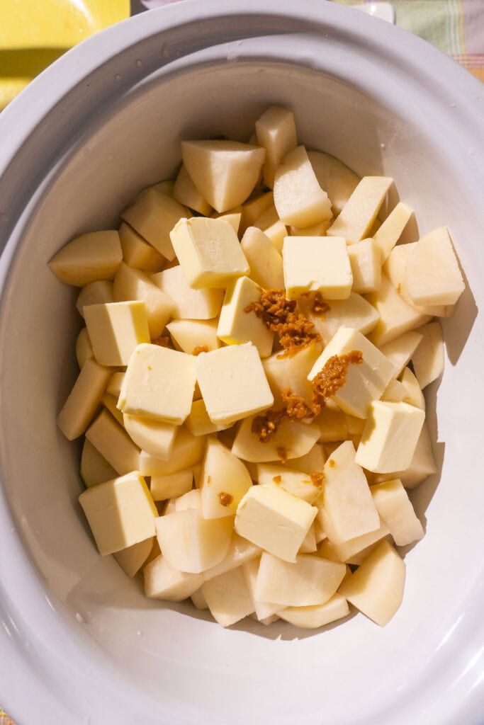 potatoes, butter and minced garlic, uncooked in crockpot.