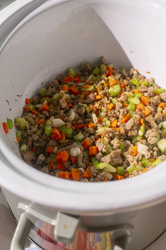 browned sausage and veggies in crockpot.