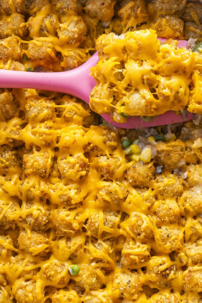 spatula scooping out tater tot casserole