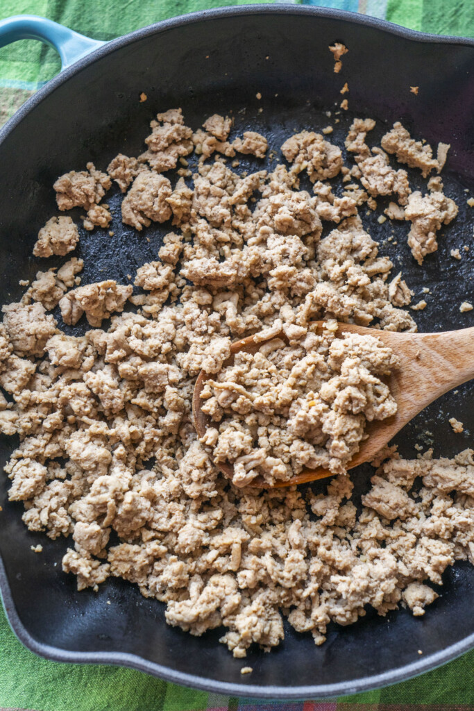 Browned ground turkey cooking in a skillet.