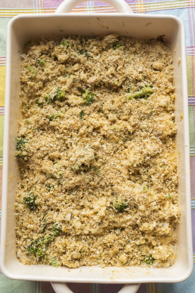 Unbaked turkey and broccoli rice casserole topped with breadcrumbs in a baking dish, ready for the oven.