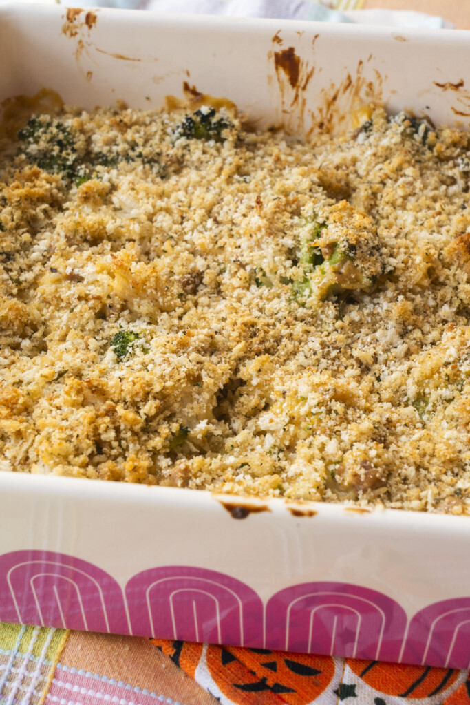 Side view of a freshly baked ground turkey and broccoli rice casserole with a golden brown breadcrumb topping.
