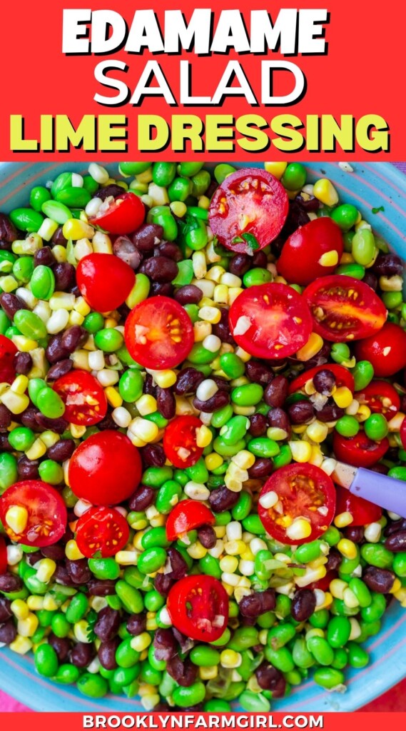 Colorful salad with edamame, black beans, corn, and cherry tomatoes, topped with lime dressing, served in a blue bowl. Text above reads Edamame Salad Lime Dressing. Source: brooklynfarmgirl.com.