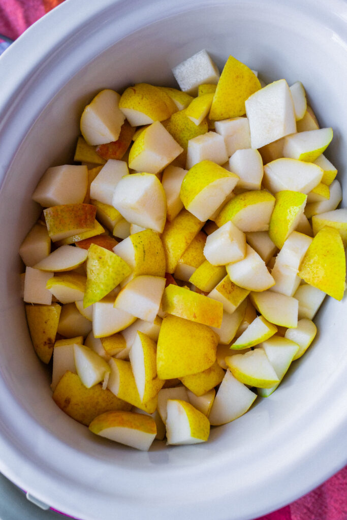 A white bowl filled with chopped yellow pears.